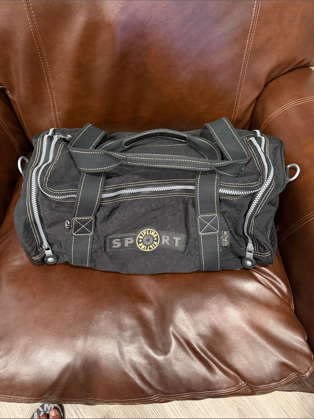 Kipling Black Duffel Bag with Yellow Logo Accent